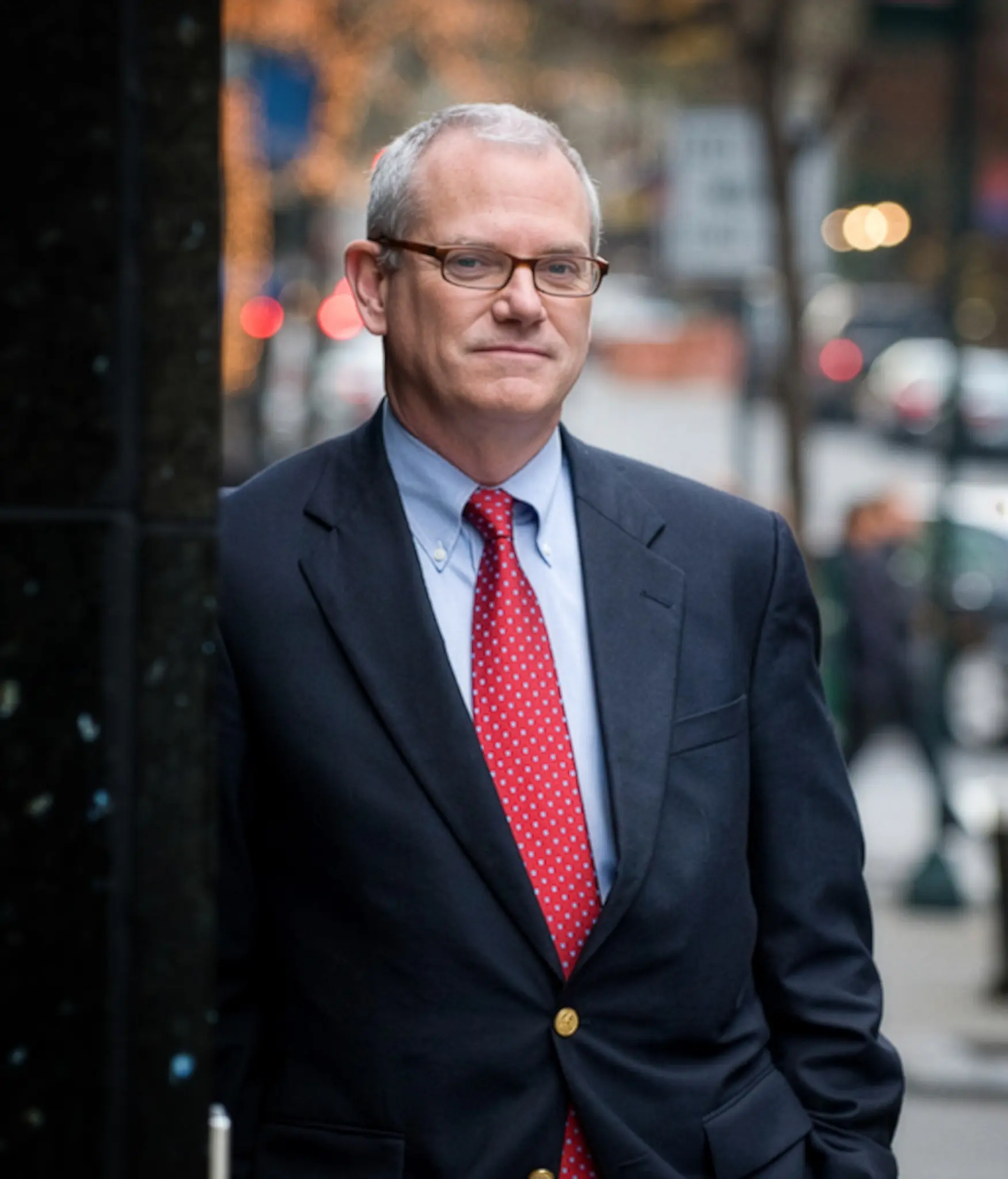 Man in a red tie standing outdoors
