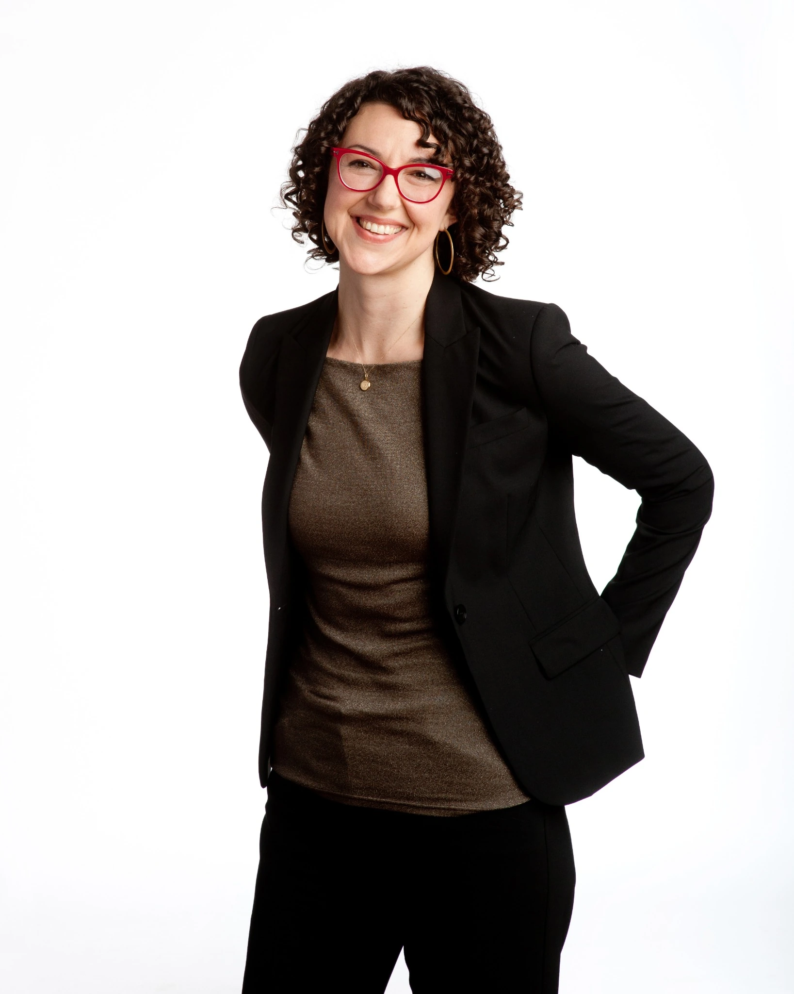 Full-length portrait of a woman in a black suit against a white background
