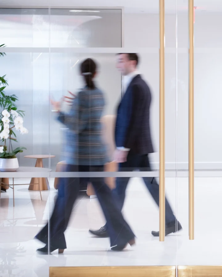 Colleagues walking through an office